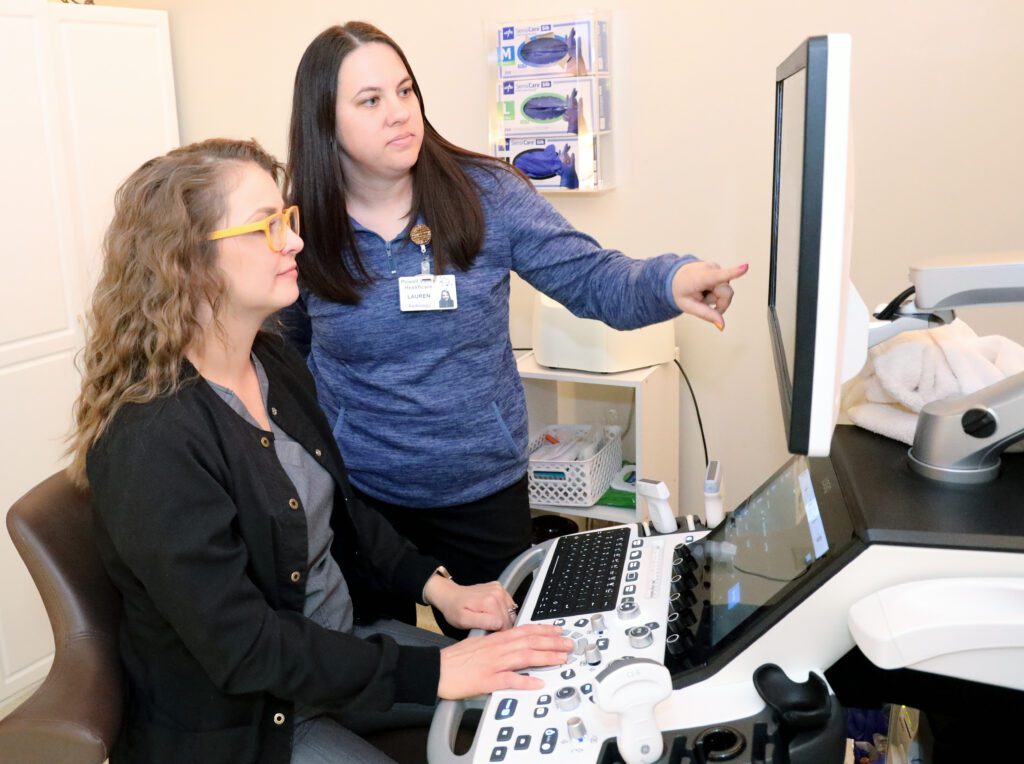 Radiology Technologists, Brooke Grubb and Lauren Showalter, work with the new ultrasound equipment received from the Helmsley grant.